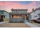 Renovated two-story home with gray siding and brick accents at sunset at 929 Rutledge Ave, Charleston, SC 29403