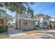 Two-story home with gray siding, brick base, and a driveway at 929 Rutledge Ave, Charleston, SC 29403
