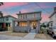 Charming two-story home with gray brick facade and a welcoming front porch at 929 Rutledge Ave, Charleston, SC 29403