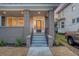 Front porch with brick columns and a black door at dusk at 929 Rutledge Ave, Charleston, SC 29403