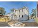 Two-story house with a light beige exterior, new landscaping, and a fenced backyard at 929 Rutledge Ave, Charleston, SC 29403