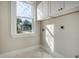 Bright laundry room with white cabinets and herringbone floor at 929 Rutledge Ave, Charleston, SC 29403