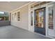 Front porch with gray painted floor and a black front door at 929 Rutledge Ave, Charleston, SC 29403