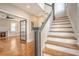 Elegant staircase with dark gray railings and hardwood steps at 929 Rutledge Ave, Charleston, SC 29403