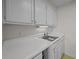 Galley kitchen with white countertops and stainless steel sink at 1 King St # 503, Charleston, SC 29401