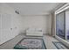 Living room with sofa, rug and access to balcony at 1 King St # 503, Charleston, SC 29401
