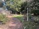 Landscaped backyard with a curved pathway and garden at 109 Quaker Rd, Saint George, SC 29477