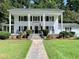 Two-story white house with columns, a walkway, and lush lawn at 109 Quaker Rd, Saint George, SC 29477