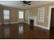 Living room with hardwood floors, fireplace, and built-in shelving at 109 Quaker Rd, Saint George, SC 29477