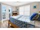 Bedroom with wooden bed, ocean view, and blue bedding at 1308 Palmetto Blvd Blvd, Edisto Beach, SC 29438