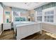 Bedroom with white queen bed, nightstands, and window seating at 1308 Palmetto Blvd Blvd, Edisto Beach, SC 29438