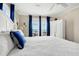 Primary bedroom with ocean view and white bedding at 1308 Palmetto Blvd Blvd, Edisto Beach, SC 29438