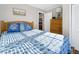 Bedroom with double bed, dresser, and blue and white bedding at 1308 Palmetto Blvd Blvd, Edisto Beach, SC 29438