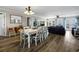Bright dining area with white table and chairs, hardwood floors, and ocean view at 1308 Palmetto Blvd Blvd, Edisto Beach, SC 29438