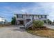 Two-story beach home with white exterior and stairs at 1308 Palmetto Blvd Blvd, Edisto Beach, SC 29438