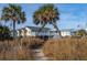 Beachfront home with deck, walkway, and lush landscaping at 1308 Palmetto Blvd Blvd, Edisto Beach, SC 29438