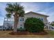Beach house with large palm tree and propane tank at 1308 Palmetto Blvd Blvd, Edisto Beach, SC 29438