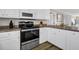 Well-equipped kitchen with white cabinets at 1308 Palmetto Blvd Blvd, Edisto Beach, SC 29438