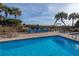 Refreshing pool with lounge chairs and palm trees at 1308 Palmetto Blvd Blvd, Edisto Beach, SC 29438