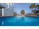 Sparkling blue pool with surrounding patio at 1308 Palmetto Blvd Blvd, Edisto Beach, SC 29438