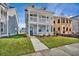 Two-story home with light blue siding, white trim, and a front yard at 131 Cantona Dr, Summerville, SC 29483