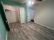 Bedroom with grey wood-look flooring and access to closets at 139 Blue Jasmine Ln, Summerville, SC 29483