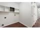 Bright laundry room with wood floors, white walls, and multiple wooden storage racks at 139 Blue Jasmine Ln, Summerville, SC 29483