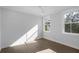 Well-lit bedroom featuring hardwood floors and two windows at 1461 Lieben Rd, Mount Pleasant, SC 29466