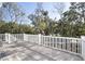 Relaxing deck with white railings and wooded backdrop at 1461 Lieben Rd, Mount Pleasant, SC 29466