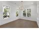 Bright dining room with hardwood floors, chandelier, and large windows at 1461 Lieben Rd, Mount Pleasant, SC 29466