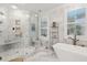 Spa-like bathroom with marble tile, walk-in shower, and freestanding tub at 15 31St Ave, Isle of Palms, SC 29451