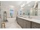 Luxurious bathroom with marble finishes, double vanity, and a soaking tub at 15 31St Ave, Isle of Palms, SC 29451