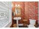Charming powder room with patterned wallpaper and pedestal sink at 15 31St Ave, Isle of Palms, SC 29451