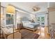Spacious bedroom with hardwood floors, a ceiling fan, and access to a private balcony at 15 31St Ave, Isle of Palms, SC 29451