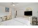 Cozy bedroom with a white bed, desk, and flat-screen TV at 15 31St Ave, Isle of Palms, SC 29451