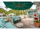 Relaxing deck with striped couches, umbrella, and outdoor seating at 15 31St Ave, Isle of Palms, SC 29451