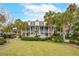 Two-story house with a large front yard, palm trees, and a basketball hoop at 15 31St Ave, Isle of Palms, SC 29451