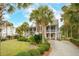 Two-story house with a large front yard, palm trees, and a basketball hoop at 15 31St Ave, Isle of Palms, SC 29451