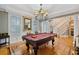 Elegant game room with pool table, hardwood floors, and view of staircase at 15 31St Ave, Isle of Palms, SC 29451