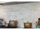 Close-up of kitchen stove with copper pots and marble backsplash at 15 31St Ave, Isle of Palms, SC 29451