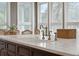 Kitchen island with a marble countertop and a stylish bridge faucet at 15 31St Ave, Isle of Palms, SC 29451