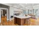 Open kitchen boasting a large island, custom cabinetry, and hardwood floors at 15 31St Ave, Isle of Palms, SC 29451