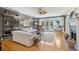 Spacious living room with fireplace, hardwood floors, and access to a deck at 15 31St Ave, Isle of Palms, SC 29451