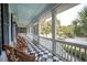 Screened porch with checkerboard floor and wicker furniture at 15 31St Ave, Isle of Palms, SC 29451