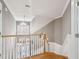 Elegant staircase with white railings and hardwood floors at 15 31St Ave, Isle of Palms, SC 29451