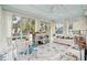 Sun-drenched sunroom with a white couch and a whimsical feel at 15 31St Ave, Isle of Palms, SC 29451