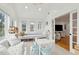 Sunroom with built-in window seat, whitewashed walls, and plenty of natural light at 15 31St Ave, Isle of Palms, SC 29451