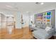 Bright sitting area with hardwood floors, comfy couch, and colorful wall art at 15 31St Ave, Isle of Palms, SC 29451