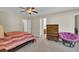 Main bedroom with king bed, dresser, and purple chair at 153 Instructor Ct, Ladson, SC 29456
