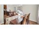 Bright dining room features a wood table, four chairs, and a sunflower table runner at 153 Instructor Ct, Ladson, SC 29456